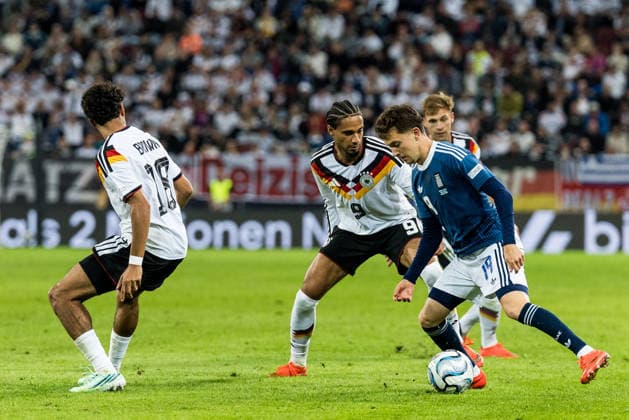 AUGSBURG, GERMANY - SEPTEMBER 27: Konstantinos Karetsas (Greece, 19) controls the ball against Kevin Schade (Germany, 9) during the UEFA Nations League match between Germany vs. Greece at WWK Arena on matchday 2 of the UEFA Nations League on September 27, 2026 in Augsburg, Germany. Bavaria Germany Copyright: xSteffiexWunderlx