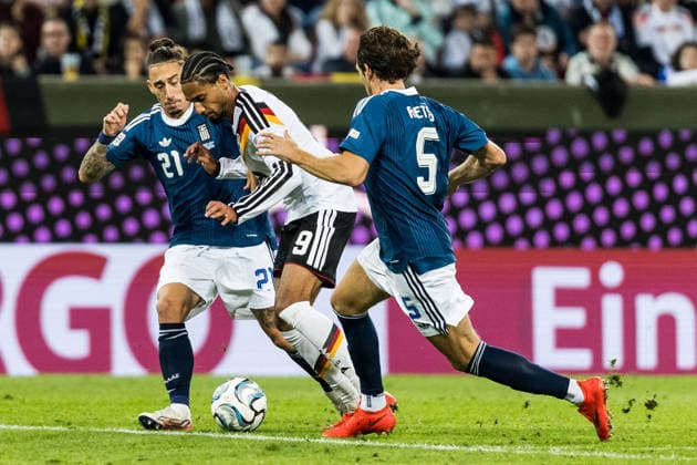 AUGSBURG, GERMANY - SEPTEMBER 27: Kevin Schade (Germany, 9) controls the ball against Kostas Tsimikas (Greece, 21) and Panagiotis Retsos (Greece, 5) during the UEFA Nations League match between Germany vs. Greece at WWK Arena on matchday 2 of the UEFA Nations League on September 27, 2026 in Augsburg, Germany. Bavaria Germany Copyright: xSteffiexWunderlx