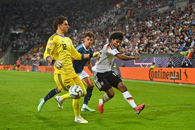 Karim ADEYEMI (GER), Giorgiow VAGIANNIDIS (GRE), goalkeeper Kostas TZOLAKIS (GRE), action, tackle; UEFA Nations League group stage, Group B, Matchday 2: Germany (GER) vs. Greece (GRE) 0–1, on September 27, 2026, WWK ARENA AUGSBURG