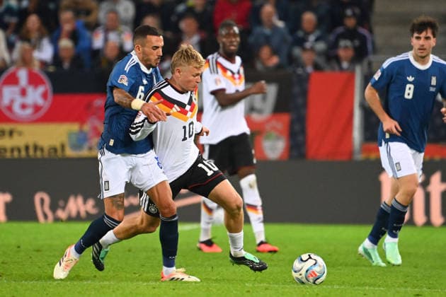Jonathan BURKARDT (GER), Action, Tackle against Dimitris KOURBELIS (GRE), UEFA Nations League Group Stage, Group B, Matchday 2: Germany (GER) vs. Greece (GRE) 0–1, on September 27, 2026, WWK ARENA AUGSBURG