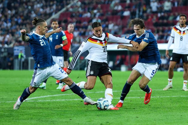 September 27, 2026, GER, Soccer, Men s, UEFA Nations League, League A, 2026–2027 Season, Matchday 2, Germany vs. Greece: Kostas Tsimikas (Greece, 21), left; Younes Ebnoutalib (Germany, 23), center; Panagiotis Retsos (Greece, 5), right. DFB and DFL regulations prohibit any use of photographs as image sequences and or quasi-video. Augsburg WWK Arena, Bavaria, Germany Copyright: xNordphoto Schneiderx