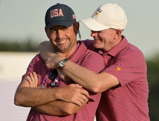 Scottie Scheffler (L) jokes with US Team Captain Brandt Snedeker after the United States team defeated the International Team 15.5 to 12.5 in the 2026 President s Cup golf tournament at Medinah Country Club in Chicago, Illinois, on Sunday, September 27, 2026. .  CHI20260927847 MARKxBLACK