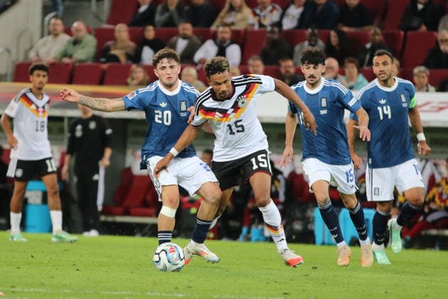 September 27, 2026 Men s Soccer 2026–2027 UEFA Nations League Matchday 2 Germany vs. Greece WWK Arena, Augsburg Bambase Conte (Germany, 15, in white) goes head-to-head with Christos Zafeiris (Greece, 20, in blue) Augsburg, Bavaria, Germany