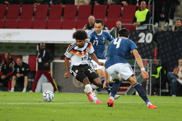 September 27, 2026 Men s Soccer 2026–2027 UEFA Nations League Matchday 2 Germany vs. Greece WWK Arena, Augsburg Karim Adeyemi (Germany, 19, in white) has the ball; Manolis Saliakas (Greece, 17, in blue) tries to stop him Augsburg, Bavaria, Germany