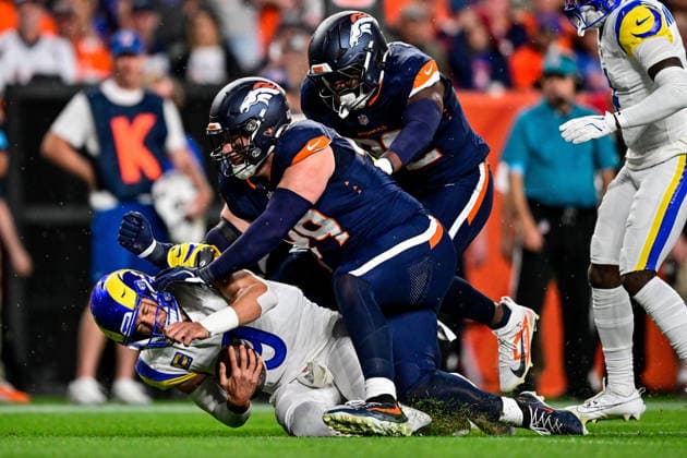 DENVER, CO - SEPTEMBER 27: Los Angeles Rams quarterback Matthew Stafford (9) is tackled by Denver Broncos defensive end Zach Allen (99) after a run in the first quarter during a game between the Los Angeles Rams and the Denver Broncos at Empower Field at Mile High on September 27, 2026 in Denver, Colorado. (Photo by Dustin Bradford Icon Sportswire) NFL, American Football Herren, USA SEP 27 Rams at Broncos EDITORIAL USE ONLY Icon132260927009