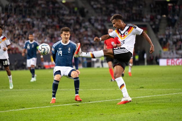 GER, Bavaria, Augsburg, Soccer, Germany vs. Greece, at the WWK Arena, Augsburg, UEFA Nations League, Matchday 2, Group Stage, September 27, 2026, From left: Konstantinos Karetsas (Greece), 19, Bambase Conte (Germany), 15, crosses the ball into the penalty area; in attack. DFL and DFB regulations prohibit any use of photographs as image sequences and or quasi-video, Copyright: HMB-Media MichaelxNibel
