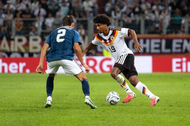 GER, Bavaria, Augsburg, Soccer, Germany vs. Greece, at the WWK Arena, Augsburg, UEFA Nations League, Matchday 2, Group Stage, September 27, 2026, from left: Giorgos Vagiannidis (Greece), 2, Karim Adeyemi (Germany), 19, in a one-on-one duel. DFL and DFB regulations prohibit any use of photographs as image sequences and or quasi-video, Copyright: HMB-Media MichaelxNibel