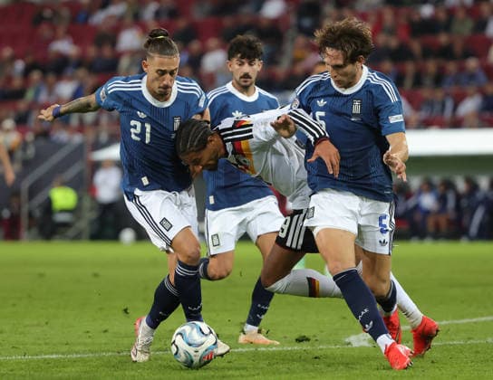 (260928) -- AUGSBURG, Sept. 28, 2026 -- Kevin Schade (2nd R) of Germany vies with Panagiotis Retsos (1st R) and Kostas Tsimikas (1st L) of Greece during the UEFA Nations League 2026 27 League A Group A match between Germany and Greece in Augsburg, Germany, Sept. 27, 2026. (Photo by Xinhua) (SP)GERMANY-AUGSBURG-UEFA NATIONS LEAGUE-LEAGUE A-GERMANY VS GREECE PhilippexRuiz 