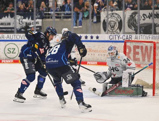 From left: Adam Helewka, 13, Dresden, and Alec Ahlroth, 28, Dresden, in front of goalie Konrad Fiedler of Ravensburg; Dresden Eislöwen vs. Ravensburg Towerstars; ice hockey; Dresden; Eisloewen; DEL2; DEL 2, 2nd Division, 2026–2027 season, JOYNEXT Arena in Ostragehege, September 27, 2026,