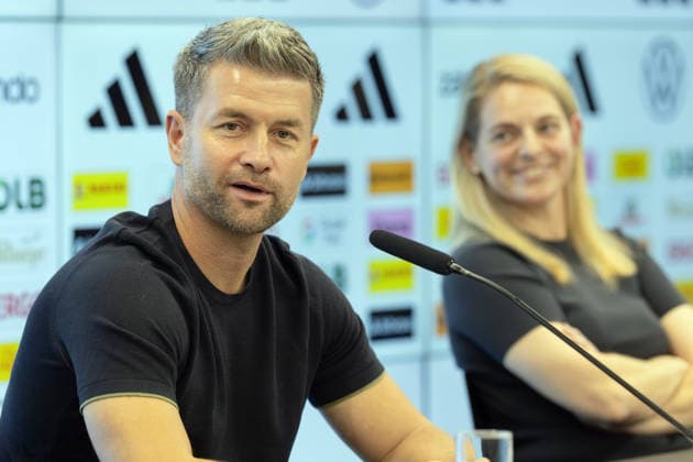 Press Conference on the Roster Announcement for the Women s U-23 National Team: Head Coach Michael Urbansky speaks during the press conference; DFB Sports Director Nia Künzer is seen in the background on the right. Press conference held at the DFB Campus in Frankfurt am Main on September 29, 2026; Frankfurt am Main, Hesse, Germany; DFB Campus