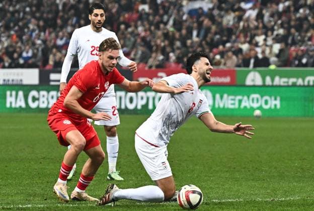 Russia Soccer Friendly Russia - Iran 9253972 29.09.2026 Russia s Maksim Glushenkov and Iran s Saeid Ezatolahi struggle for a ball during the friendly soccer match between Russia and Iran at Ak Bars Arena stadium, in Kazan, Republic of Tatarstan, Russia. Maksim Bogodvid Sputnik Kazan Republic of Tatarstan Russia  Copyright: xMaksimxBogodvidx