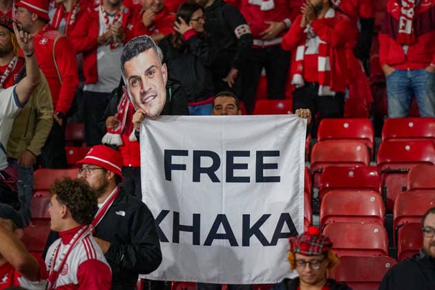 Soccer: UEFA Nations League 2026–2027, Matchday 2: Scotland vs. Switzerland at Hampden Park, Glasgow Swiss fans at Hampden Park during the Scotland vs. Switzerland match A fan holds up a banner reading FREE XHAKA as well as a mask featuring the face of Granit Xhaka Soccer, UEFA Nations League, Switzerland, Granit Xhaka, fans, spectators, stands, banner, protest, solidarity, fan culture, Swiss national team, SFV, Hampden Park, Glasgow Copyright: xJOERANxSTEINSIEKx