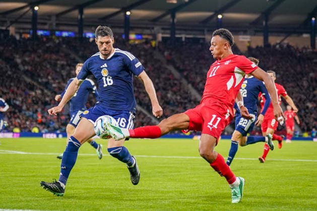 Soccer: UEFA Nations League 2026–2027, Matchday 2: Scotland vs. Switzerland at Hampden Park, Glasgow—Dan Ndoye (Switzerland, No. 11) and Scott McKenna (Scotland, No. 16) in a tackle Copyright: xJOERANxSTEINSIEKx