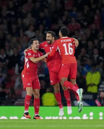 Ricardo Rodriguez of Switzerland celebrates with team mates Zeki Amdouni & Zachary Athekame after scoring a direct free-kick to guve the Swiss a 0-1 lead. Scotland v Switzerland, Football, UEFA Nation s League, Group B1, Hampden Park, Glasgow, UK, Hampden Park, Glasgow, Scotland, Scotland, UK - 29 Sep 2026Glasgow Hampden Park Scotland United Kingdom Copyright: xStuartxWallace Shutterstockx 17176216bj