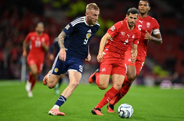 Glasgow, Scotland, 29th September 2026. Oli McBurnie of Scotland and Remo Freuler of Switzerland during the Scotland vs Switzerland UEFA Nations League match at Hampden Park, Glasgow. Picture credit should read: Neil Hanna Sportimage EDITORIAL USE ONLY. No use with unauthorised audio, video, data, fixture lists, club league logos or live services. Online in-match use limited to 120 images, no video emulation. No use in betting, games or single club league player publications. SPI_079_Scotland_Switzerland SPI-5047-0079