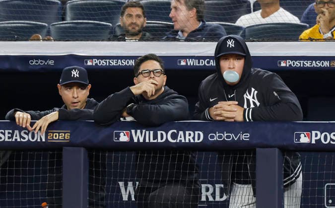 New York Yankees right fielder Aaron Judge (99) blows a bubble as he watches from the dugout as the Yankees play the Boston Red Sox in the sixth inning of an MLB, Baseball Herren, USA American League Wild Card game at Yankee Stadium in New York City, on Wednesday, September 30, 2026. Judge is currently suffering from a calf injury and not on the roster for the Wild Card series.  NYP20260930718 JOHNxANGELILLO