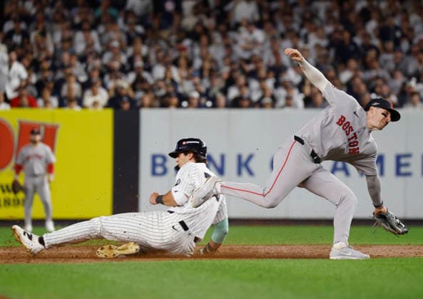 New York Yankees Spencer Jones (78) slides into third past Boston Red Sox third baseman Caleb Durbin (5) in the sixth inning of an MLB, Baseball Herren, USA American League Wild Card game at Yankee Stadium in New York City, on Wednesday, September 30, 2026.  NYP20260930722 JOHNxANGELILLO