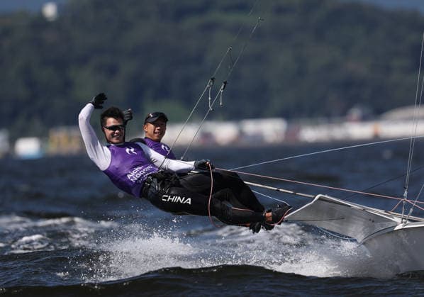 (261001) -- GAMAGORI, Oct. 1, 2026 -- Liu Tian (front) and Wen Zaiding of China celebrate after the Men s Skiff Opening Series Race of Sailing at the 20th Asian Games Aichi-Nagoya 2026 in Gamagori of Aichi Prefecture, Japan, Oct. 1, 2026. ) (SP)JAPAN-GAMARORI-ASIAN GAMES-SAILING-MEN S SKIFF DengxHua 