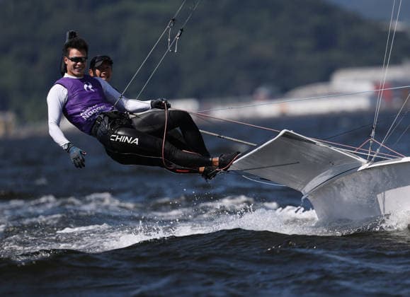 (261001) -- GAMAGORI, Oct. 1, 2026 -- Liu Tian (front) and Wen Zaiding of China celebrate after the Men s Skiff Opening Series Race of Sailing at the 20th Asian Games Aichi-Nagoya 2026 in Gamagori of Aichi Prefecture, Japan, Oct. 1, 2026. ) (SP)JAPAN-GAMAGORI-ASIAN GAMES-SAILING-MEN S SKIFF DengxHua 