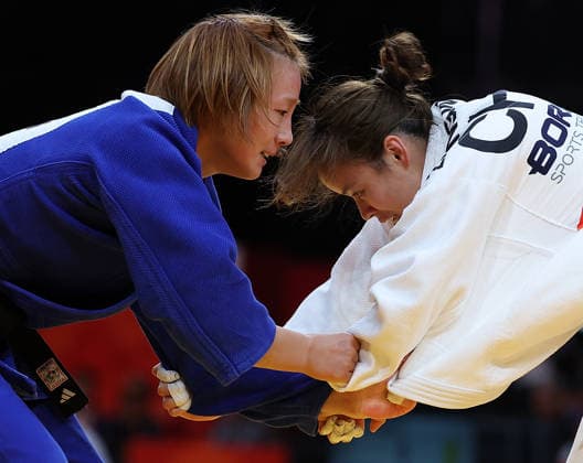 (261001) -- NAGOYA, Oct. 1, 2026 -- Zhang Wen (R) of China competes with Kim Jisu of South Korea during the women -63kg repechage of Judo at the 20th Asian Games Aichi-Nagoya 2026 in Nagoya, Japan, Oct. 1, 2026. ) (SP)JAPAN-NAGOYA-ASIAN GAMES-JUDO-WOMEN -63KG YaoxQilin 