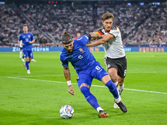 Nemanja Gudelj of Serbia and Tom Bischof of Germany battle for the ball during the UEFA Nations League 2026-27 group stage match between Germany and Serbia at Allianz Arena on October 1, 2026, in Munich, Germany. Photo by Harry Langer, DeFodi Images