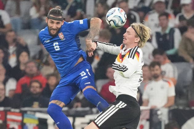Heading duel: Nemanja Gudelj (Serbia) vs. Nick Woltemade (Germany), Munich, October 1, 2026; Germany vs. Serbia, UEFA Nations League, Matchday 3, Allianz Arena
