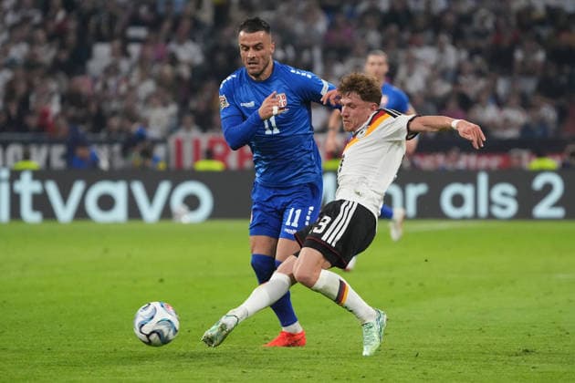 Philipp Treu (Germany) takes the ball away from Filip Kostic (Serbia) in Munich, October 1, 2026. Germany vs. Serbia, UEFA Nations League, Matchday 3, Allianz Arena