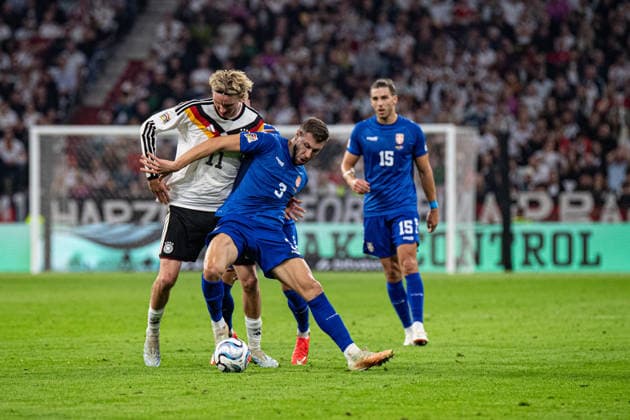 Nick Woltemade (No. 11, Germany) and Strahinja Pavlovic (No. 3, Serbia) in action during the UEFA Nations League match between Germany and Serbia on October 1, 2026, at the Allianz Arena in Munich, Bavaria, Germany