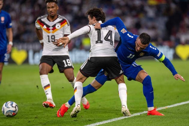 Mika Baur (GER) and Filip Kostic (SRB) xettx, Germany, Munich, October 1, 2026, Soccer, National Team, Nations League: Germany vs. Serbia, 2026–2027 Season, Matchday 3, Allianz Arena