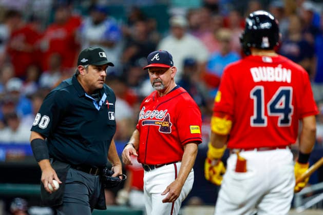 Atlanta Braves Manager Walt Weiss speaks to the home plate umpire after an unsuccessful appeal of a catchers interference in the first inning against Philadelphia Phillies in Game 3 of the National League Wildcard Series at Truist Park on Thursday, October 1, 2026 in Atlanta, Georgia.  ATL20261001103 MikexZarrilli