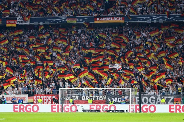 UEFA Nations League, Matchday 26–27: Germany vs. Serbia on October 1, 2026, at the Allianz Arena in Munich. German fans are waving flags in the stands. MH