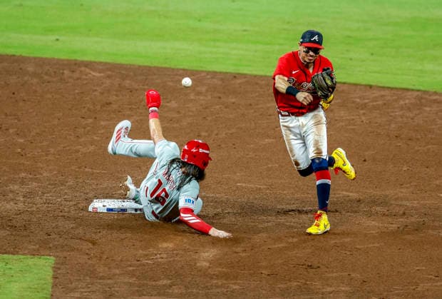 Philadelphia Phillies Brandon Marsh (16) is out by Atlanta Braves short stop Mauricio Dubon (14) after sliding into second base in the fifth inning in game three of the MLB, Baseball Herren, USA National League Wild Card round at Truist Park in Atlanta, Georgia on Thursday, October 1, 2026.  ATL20261001316 MIKExZARRILLI