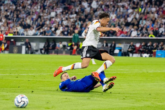 Soccer: UEFA Nations League 2026–2027, Matchday 3: Germany vs. Serbia at Allianz Arena, Munich. Derry Scherhant (Germany, No. 9) in a tackle against Nemanja Maksimovic (Serbia, No. 5) Copyright: xMichellexLukax