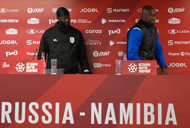 Russia Soccer Friendly Namibia Training 9256252 02.10.2026 Namibia s head coach Collin Benjamin, right, and player Deon Hotto arrive to attend a news conference on the eve of the friendly soccer match against Russia at Yekaterinburg Arena in Yekaterinburg, Russia. Grigory Sysoev Sputnik Yekaterinburg Russia  Copyright: xGrigoryxSysoevx