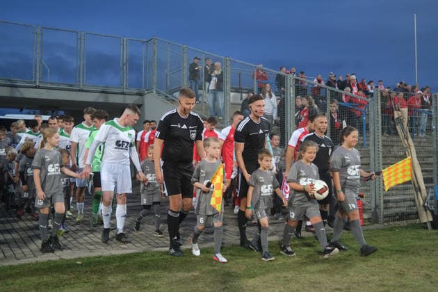 October 2, 2026 Men s Soccer 2026–2027 dachbleche24 State Cup, 2nd Round: SG Reppichau vs. Hallescher FC at Paul Greifzu Stadium, Dessau-Roßlau; Laurenz Werner, referee; Benedict Ohrdorf (Assistant Referee 1) and Marcel Meier (Assistant Referee 2) lead both teams onto the field in Dessau-Roßlau, Saxony-Anhalt, Germany