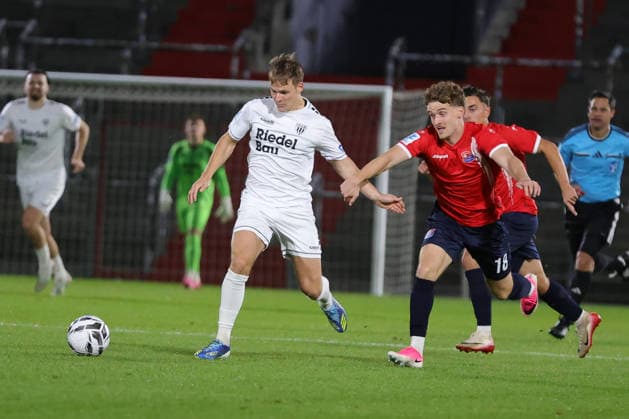 October 2, 2026, Soccer, Men s, Bavarian Regional League, 2026–2027 Season, Matchday 12: SpVgg Unterhaching vs. FC Schweinfurt 05. From left: Gil Ebner (FC Schweinfurt 05), No. 8 against Dominik Lindermeir (SpVgg Unterhaching), No. 18. Unterhaching, Uhlsport Park, Unterhaching, Bavaria, Germany