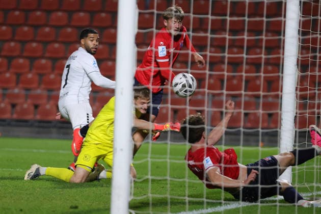 October 2, 2026, Soccer, Men s, Bavarian Regional League, 2026–2027 Season, Matchday 12: SpVgg Unterhaching vs. FC Schweinfurt 05. From left: Jason Prodanovic (FC Schweinfurt 05), No. 17, scores the 1–0 goal past goalkeeper Erion Avdija (SpVgg Unterhaching), No. 40. Unterhaching Uhlsport Park, Unterhaching, Bavaria, Germany