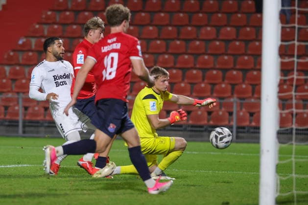 October 2, 2026, Soccer, Men s, Bavarian Regional League, 2026–2027 Season, Matchday 12: SpVgg Unterhaching vs. FC Schweinfurt 05. From left: Jason Prodanovic (FC Schweinfurt 05), No. 17, scores the 1–0 goal past goalkeeper Erion Avdija (SpVgg Unterhaching), No. 40. Unterhaching Uhlsport Park, Unterhaching, Bavaria, Germany