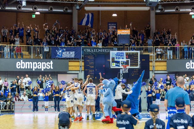 A jubilant atmosphere among the team led by Marko Dordevic, HAKRO Merlins Crailsheim; 25 Till Isemann, HAKRO Merlins Crailsheim; 21 Nico Hoellerl, HAKRO Merlins Crailsheim; 05 Simon Krajcovic HAKRO Merlins Crailsheim, 55 Luc van Slooten HAKRO Merlins Crailsheim, 11 celebrating with the fans after the victory—cheering, joy, dancing—with the Ultras fans from Crailsheim, GER, in the background, HAKRO Merlins Crailsheim vs. Tigers Tübingen, Basketball, 2nd Basketball Bundesliga, Pro A, Matchday 2, 2026–2027 season, October 2, 2026, GER, HAKRO Merlins Crailsheim vs. Tigers Tübingen, Basketball, 2nd Basketball Bundesliga, Pro A, Matchday 2, 2026–2027 season, October 2, 2026, Ilshofen Copyright: xEibner-Pressefoto JanixPlessx EP_JPL