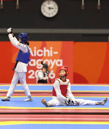 (261003) -- TOYOHASHI, Oct. 3, 2026 -- Zhang Chuling (L) of China reacts after her match with Lin Wei-chun of Chinese Taipei during the women -57kg semifinal of taekwondo at the 20th Asian Games Aichi-Nagoya 2026 in Toyohashi of Aichi Prefecture, Japan, Oct. 3, 2026. ) (SP)JAPAN-TOYOHASHI-ASIAN GAMES-TAEKWONDO-WOMEN -57KG WangxFei 