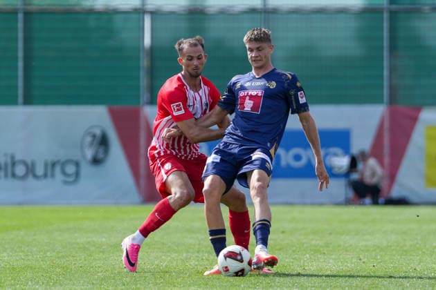 Max Rosenfelder (SC Freiburg), 37, and Lars Villiger (FC Lucerne), 27, in a tackle; Germany, soccer, friendly match, SC Freiburg vs. FC Lucerne, October 3, 2026, Europa-Park Stadium, training field, Freiburg, Europa-Park Stadium, training field, Baden-Württemberg, Germany Copyright: xArnexAmbergx