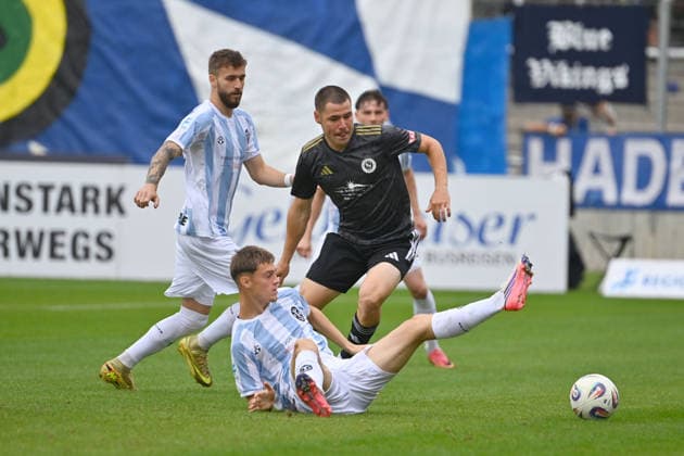 Mirko PUSCHER in action, tackling Emre ERDOGAN, 1860 Munich vs. Eric UHLMANN, 1860 Munich, Bavarian Regional League, 2026–2027 season,Matchday 26–27, December 12: TSV 1860 Munich vs. SpVgg Ansbach on October 3, 2026, at Grünwalder Stadium in Munich