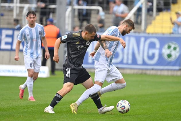 Mirko PUSCHER in action, tackling Eric UHLMANN—1860 Munich, Bavarian Regional League, 2026–2027 season,Matchday 26–27, December 12: TSV 1860 Munich vs. SpVgg Ansbach on October 3, 2026, at the Grünwalder Stadium in Munich
