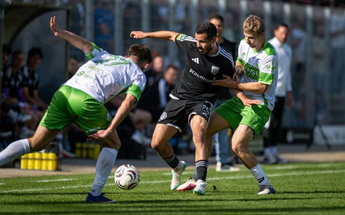 Soccer, 2026–2027 Season, Regionalliga West, October 3, 2026, Matchday 11, Men s, 1 FC Bocholt (black) vs. FC Guertsloh (white); Aleksandar Kandic (FC Guertsloh), Marvin Lorch (1 FC Bocholt), Len Wilkesmann (FC Guertsloh); Bocholt Stadium am Huenting, North Rhine-Westphalia, Germany 261003_fb_1fc-bocholt_fc-guetersloh_59442