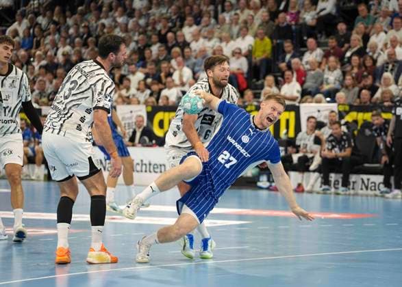 Photo: Kristjan Horzen of Gummersbach takes a shot against Harald Reinkind of Kiel in Men s Handball Bundesliga 1 on Sat, Oct 3, 2026—THW Kiel vs. VfL Gummersbach