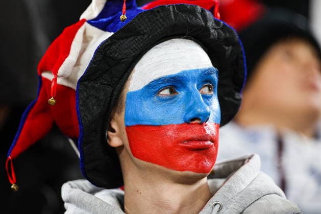 RUSSIA, YEKATERINBURG - OCTOBER 3, 2026: A man with the face painted in the colours of the Russian flag attends a friendly football match between Russia and Namibia at Yekaterinburg Arena. Mikhail Sinitsyn TASS  98727891