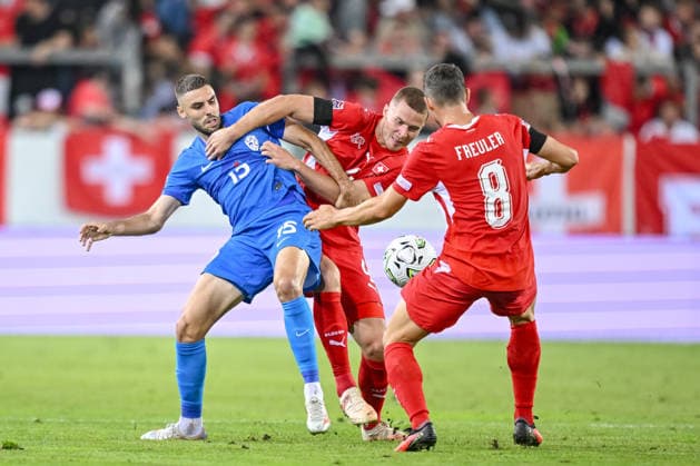 Danijel Sturm of Slovenia, Nico Elvedi of Switzerland, and Remo Freuler of Switzerland battle for the ball during the UEFA Nations League 2026–27 group stage match between Switzerland and Slovenia at Luzern Arena on October 3, 2026, in Lucerne, Switzerland. Photo by Harry Langer, DeFodi Images