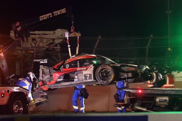 The Porsche 963 No. 7, severely damaged in an accident, with Felipe Nasr, Laurin Heinrich, and Julien Andlauer at the tow hook, IMSA racing series, 29th Motul Petit Le Mans race, Road Atlanta, Georgia, USA, October 3, 2026, Accident, Retirement, Porsche Penske Motorsport