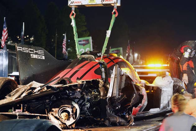 The Porsche 963 No. 7, driven by Felipe Nasr, Laurin Heinrich, and Julien Andlauer, which was severely damaged in an accident, on a tow truck in front of the Porsche Penske tent, IMSA racing series, 29th Motul Petit Le Mans race, Road Atlanta, Georgia, USA, October 3, 2026, retired,