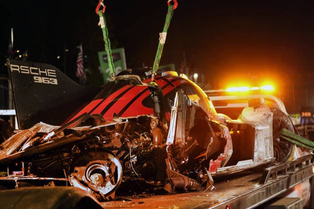 The Porsche 963 No. 7, driven by Felipe Nasr, Laurin Heinrich, and Julien Andlauer, which was severely damaged in an accident, on a tow truck in front of the Porsche Penske tent, IMSA racing series, 29th Motul Petit Le Mans race, Road Atlanta, Georgia, USA, October 3, 2026, retired,